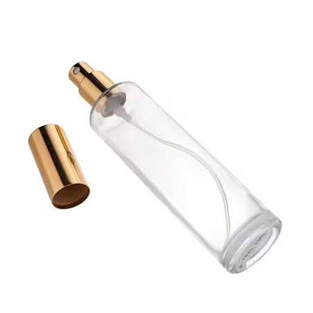 Flacon vaporisateur en verre transparent avec pompe spray dorée et bouchon métallique doré parfums, brumes ou soins cosmétiques