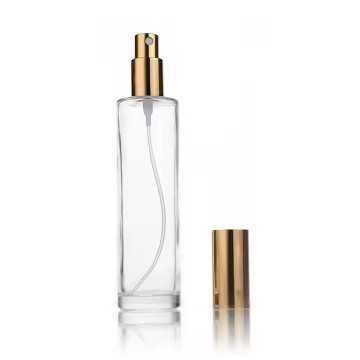 Flacon vaporisateur en verre transparent avec pompe spray dorée et bouchon métallique doré parfums, brumes ou soins cosmétiques