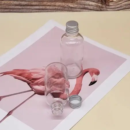 Flacon 100 ml en verre transparent avec bouchon à vis hermétique argenté - Fatipack Group Emballage Maroc