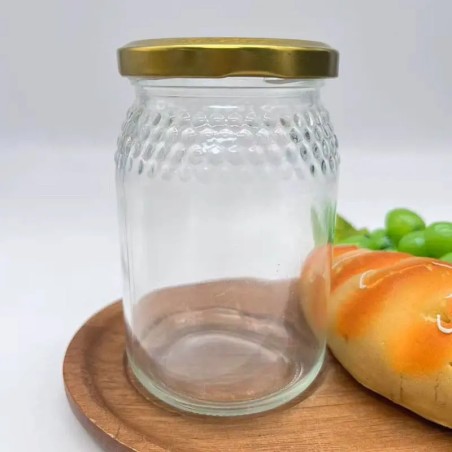 Pot de miel en verre transparent en nid d'abeille avec couvercle en métal doré - Fatipack Group Emballage Maroc